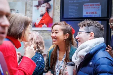 A small group of attendees chatting and smiling during a break.