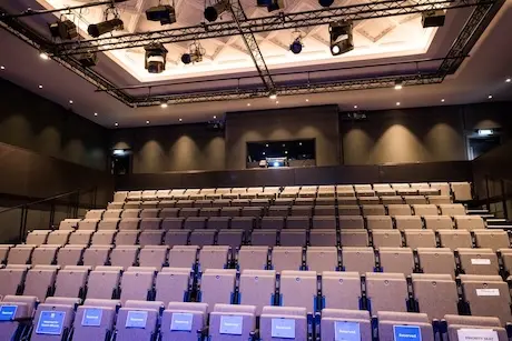 The modern interior of the Studio Theatre looking from the stage to the raked seats.